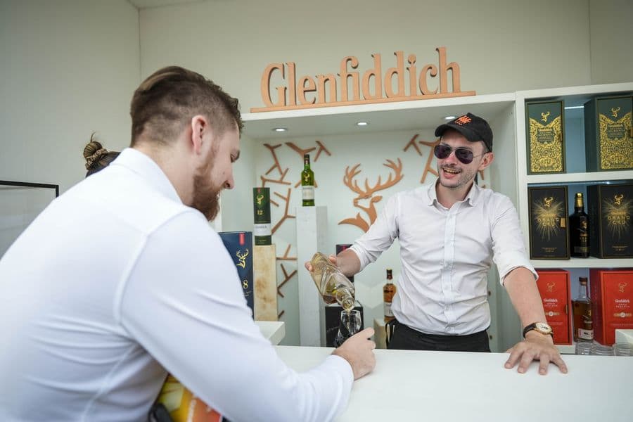 The Glenfiddich stand with hosts pouring