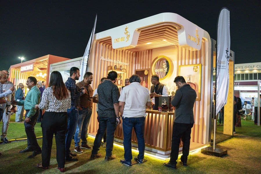 A lit pavilion interior with guests at the bar