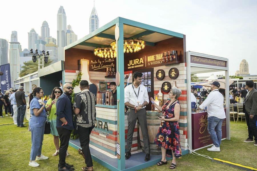 A branded pavilion with the Dubai skyline framed behind it