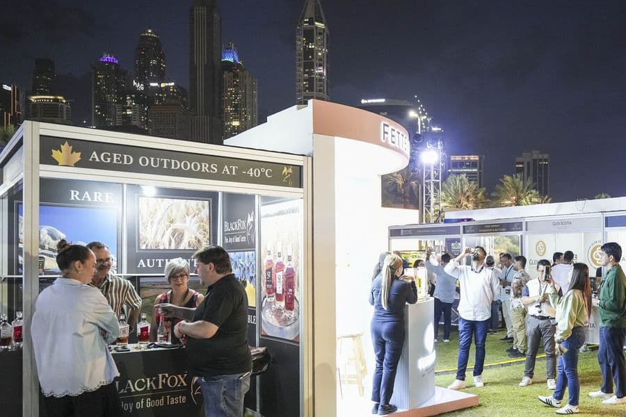 An outdoor bar stand on the lawn in the evening