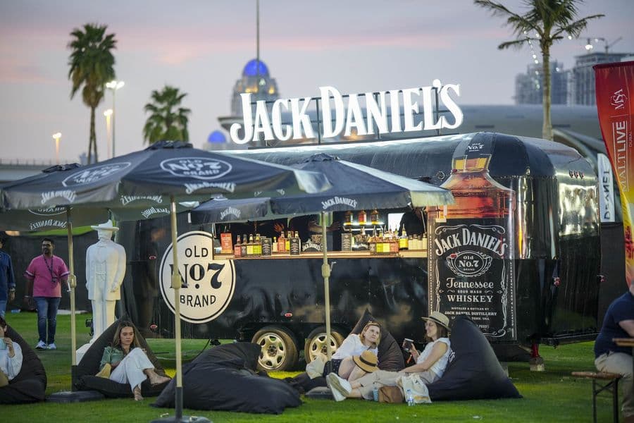 The Jack Daniel’s truck bar lit up against an evening sky