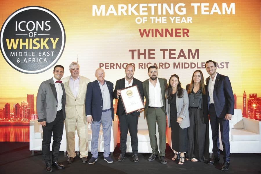 A team collecting their award on stage