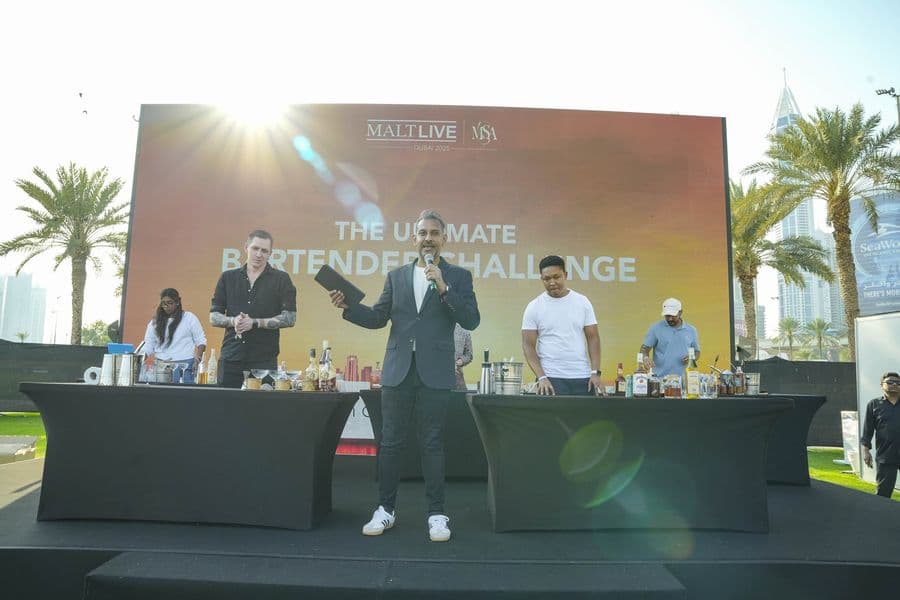A host addressing the crowd from the masterclass stage
