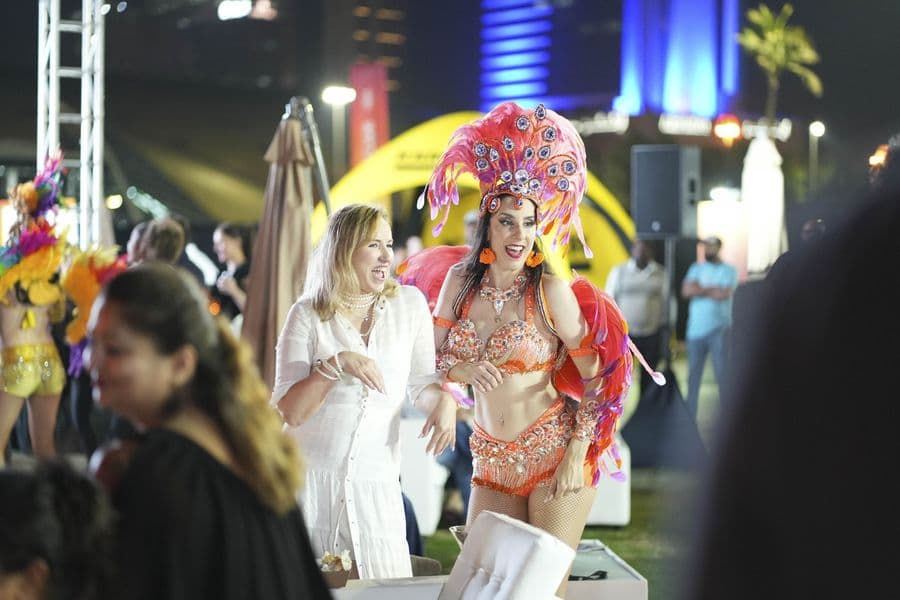 Dancers in costume moving through the crowd at night