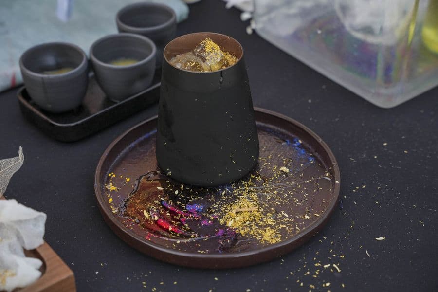A cocktail served under a smoking cloche