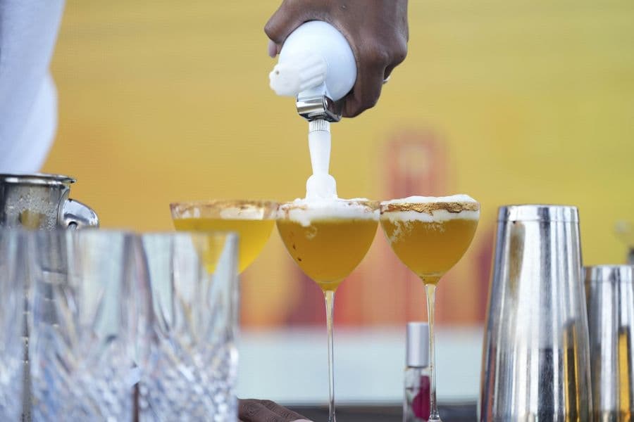 A measured pour being served into a nosing glass