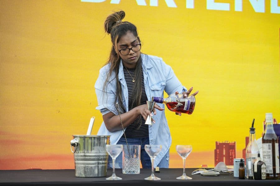 A competitor shaking a cocktail during the final
