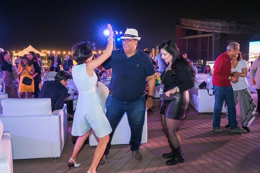 Guests dancing in front of the stage lighting