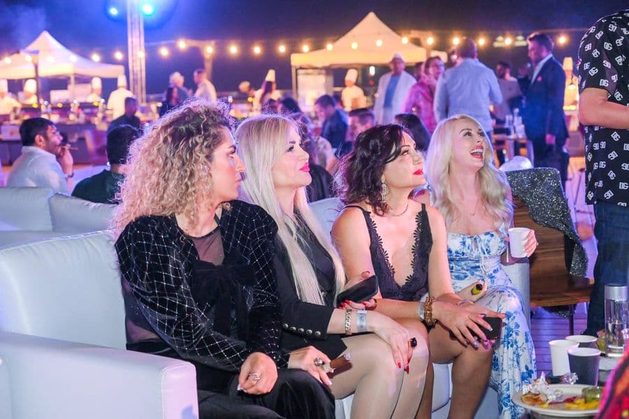 Friends together on the terrace under the lights