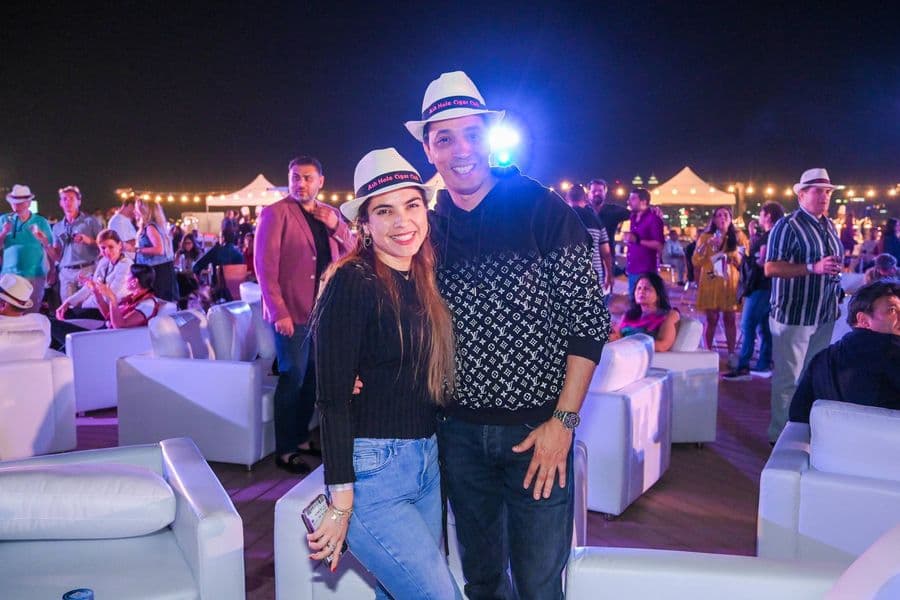 Guests in Panama hats among the night crowd