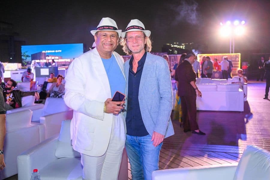 Two guests photographed on the terrace at night