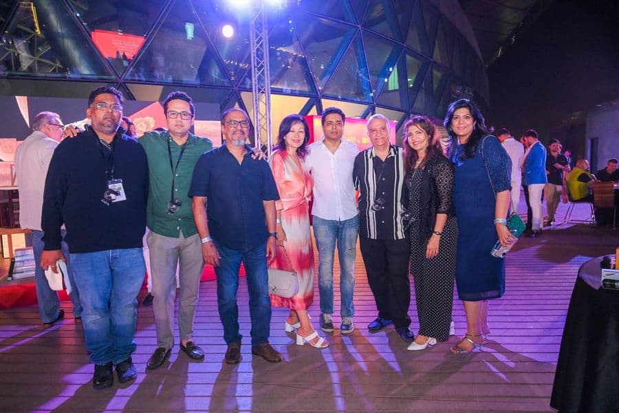 A large group photographed under the stage lights