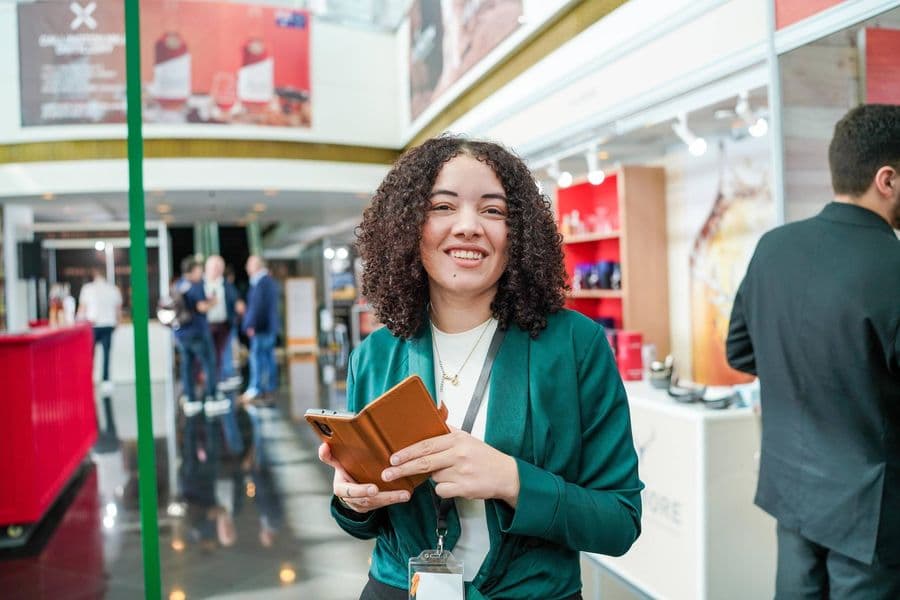 A host with the event programme in the concourse