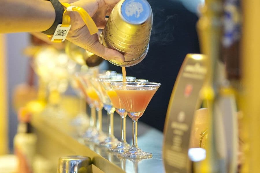 Cocktails being drawn from brass taps at the cocktail bar