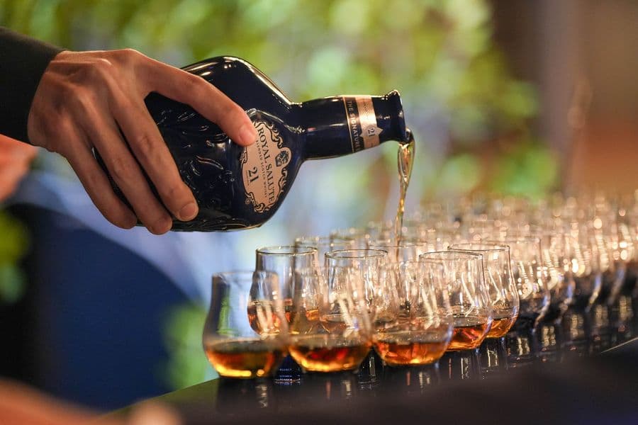 Whisky poured over a row of filled nosing glasses